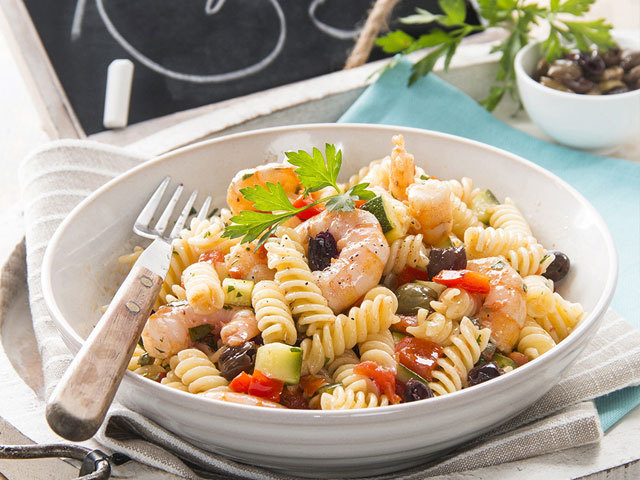 First dishes: Fusilli with vegetables, olives and prawns